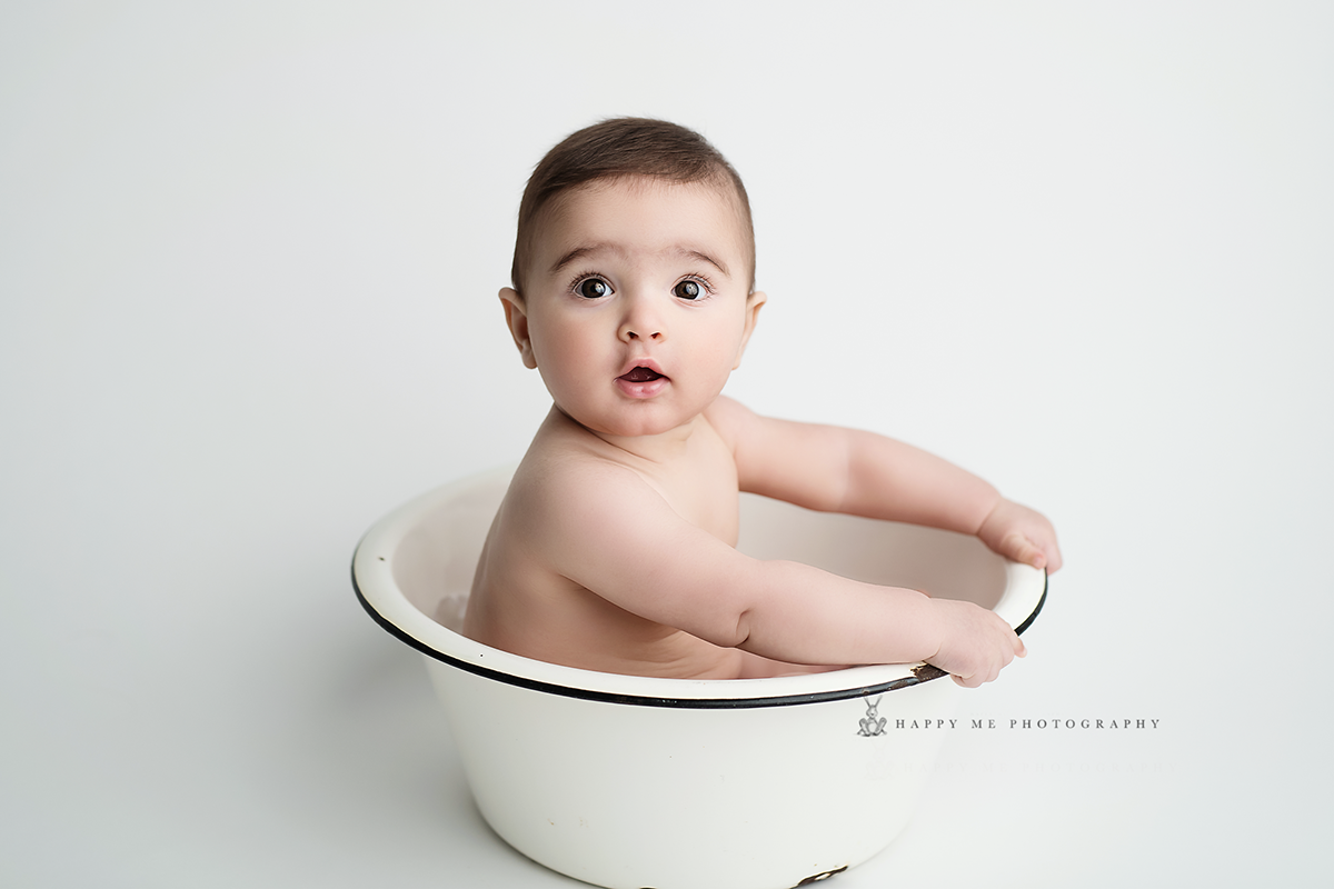 baby photography Santa Cruz County showcasing baby boy in a bowl on white backdrop